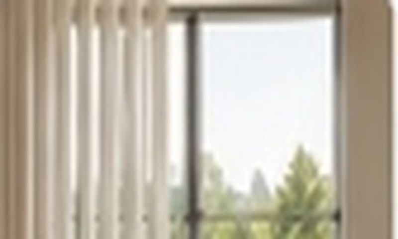 Balcony sliding doors framed with vertical blinds and expansive window treatments