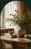Ceramic vase with green branches in arch window